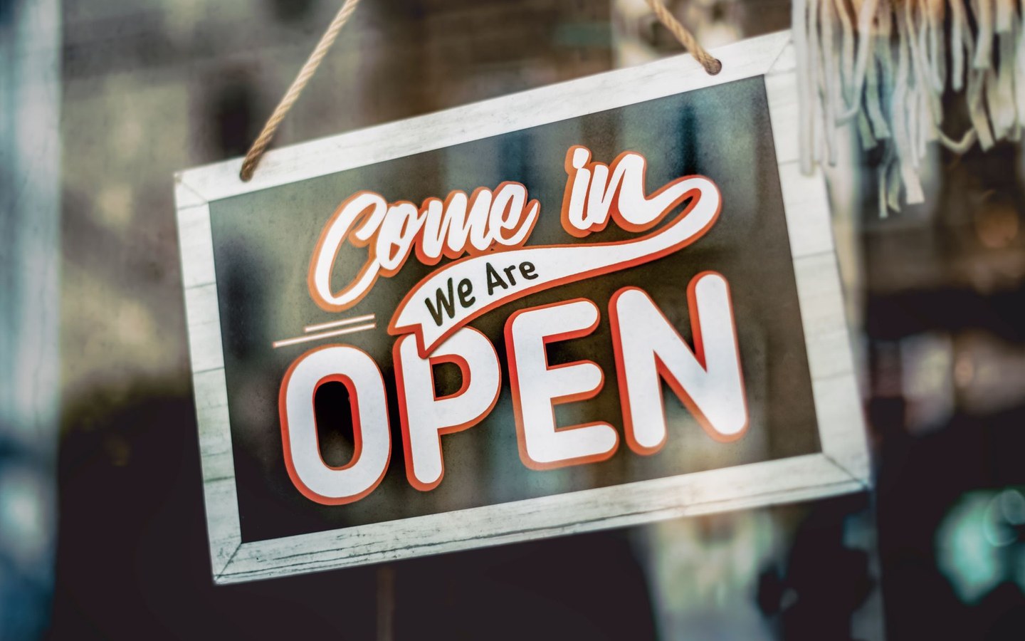 Retail store with business hours and promotional signage